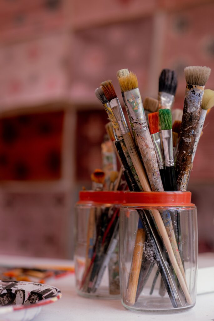 paint brushes in glass jar